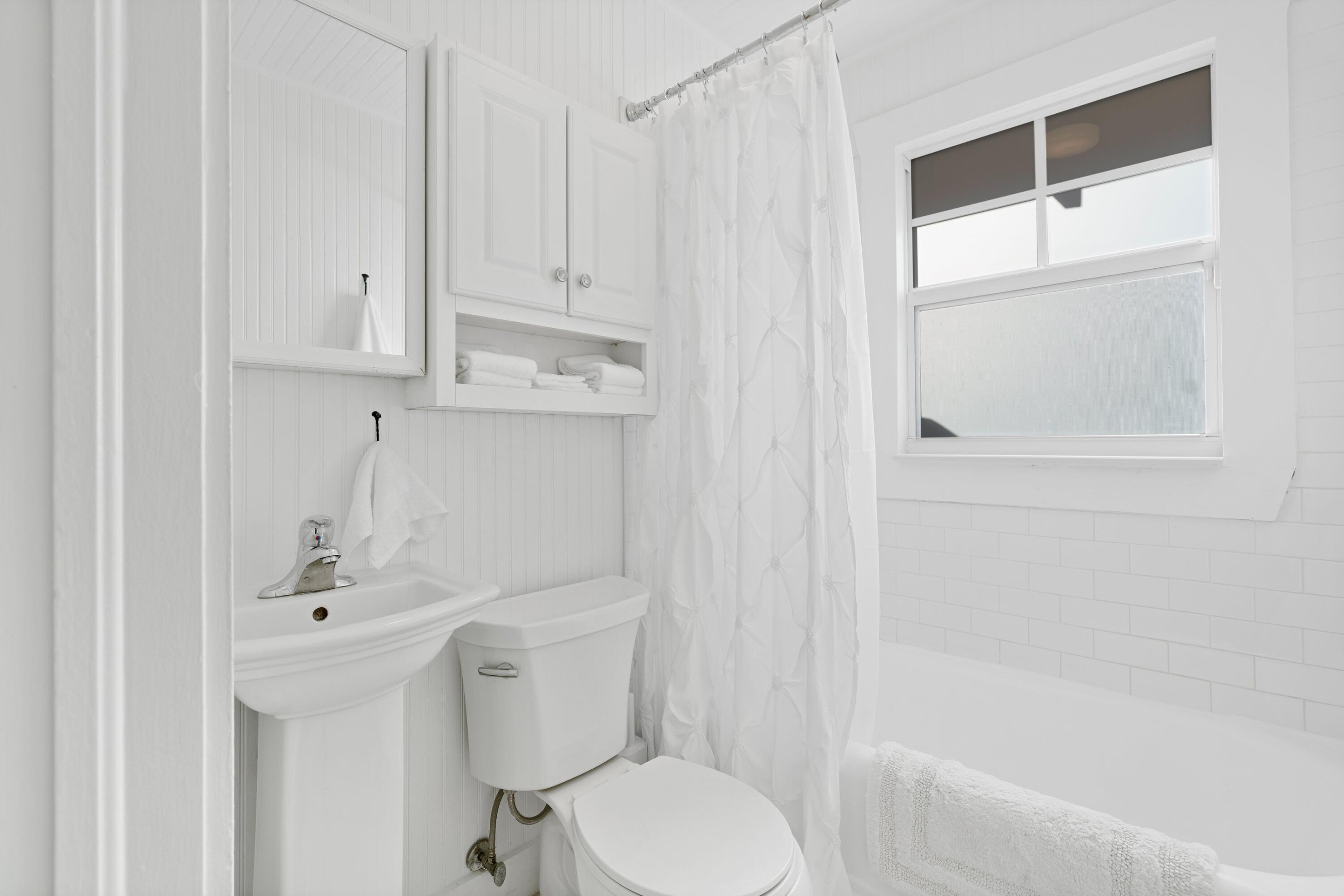 118 Southeast 7th Avenue Delray Beach, FL 33483 - Photo 9 of 17 a bathroom with a sink a toilet and shower