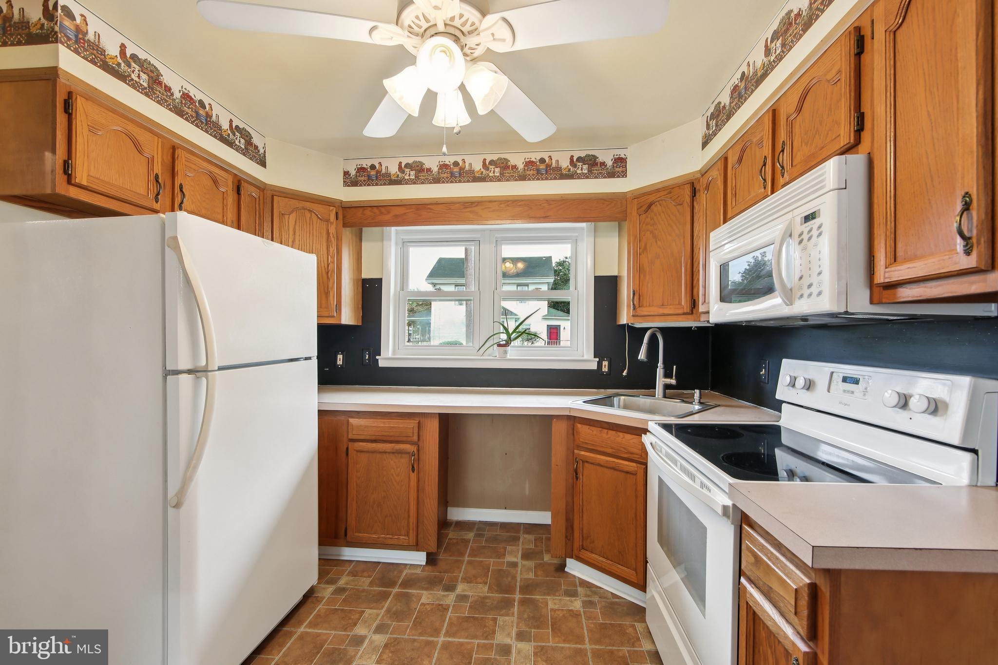200 East Roland Road Brookhaven, PA 19015 - Photo 12 of 47 a kitchen with stainless steel appliances a refrigerator a sink and cabinets
