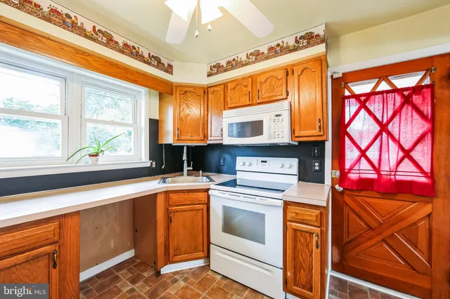 a kitchen with a stove a sink and a microwave