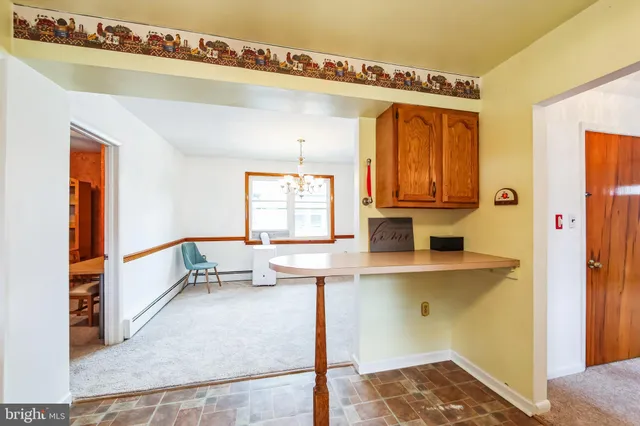 a view of kitchen with wooden floor and electronic appliances