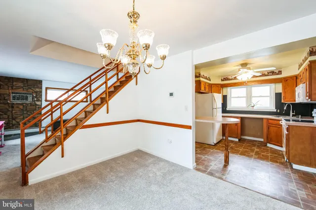 a view of entryway and hall with dining room