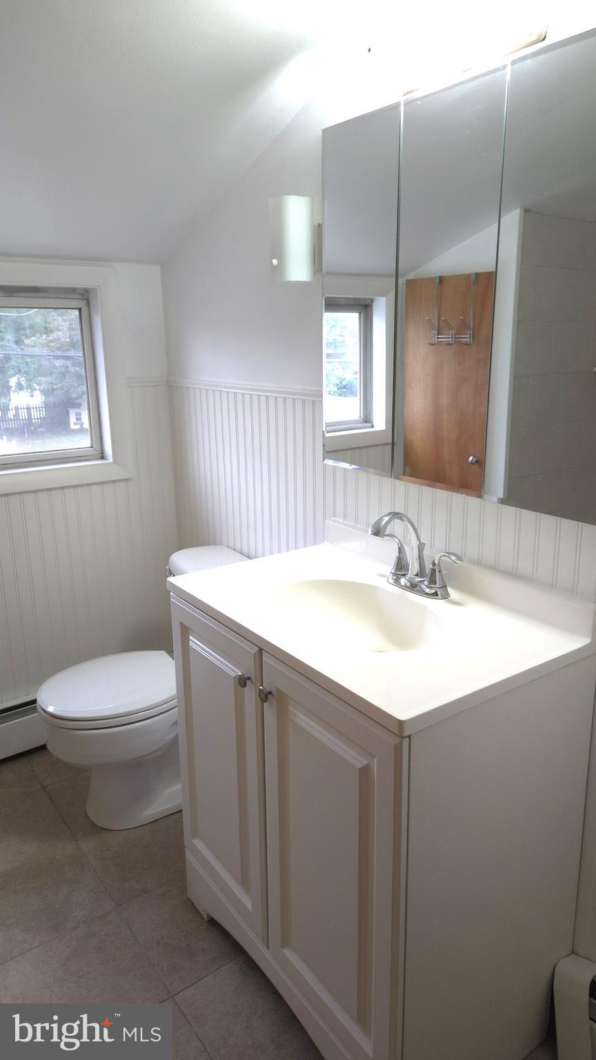 200 East Roland Road Brookhaven, PA 19015 - Photo 33 of 47 a bathroom with a sink a toilet and mirror
