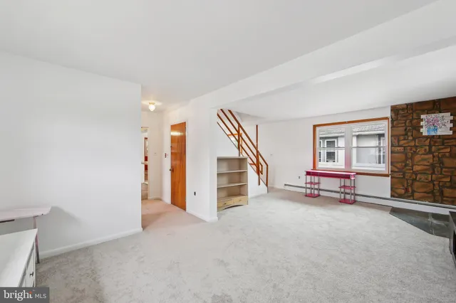 a view of a livingroom with furniture and staircase