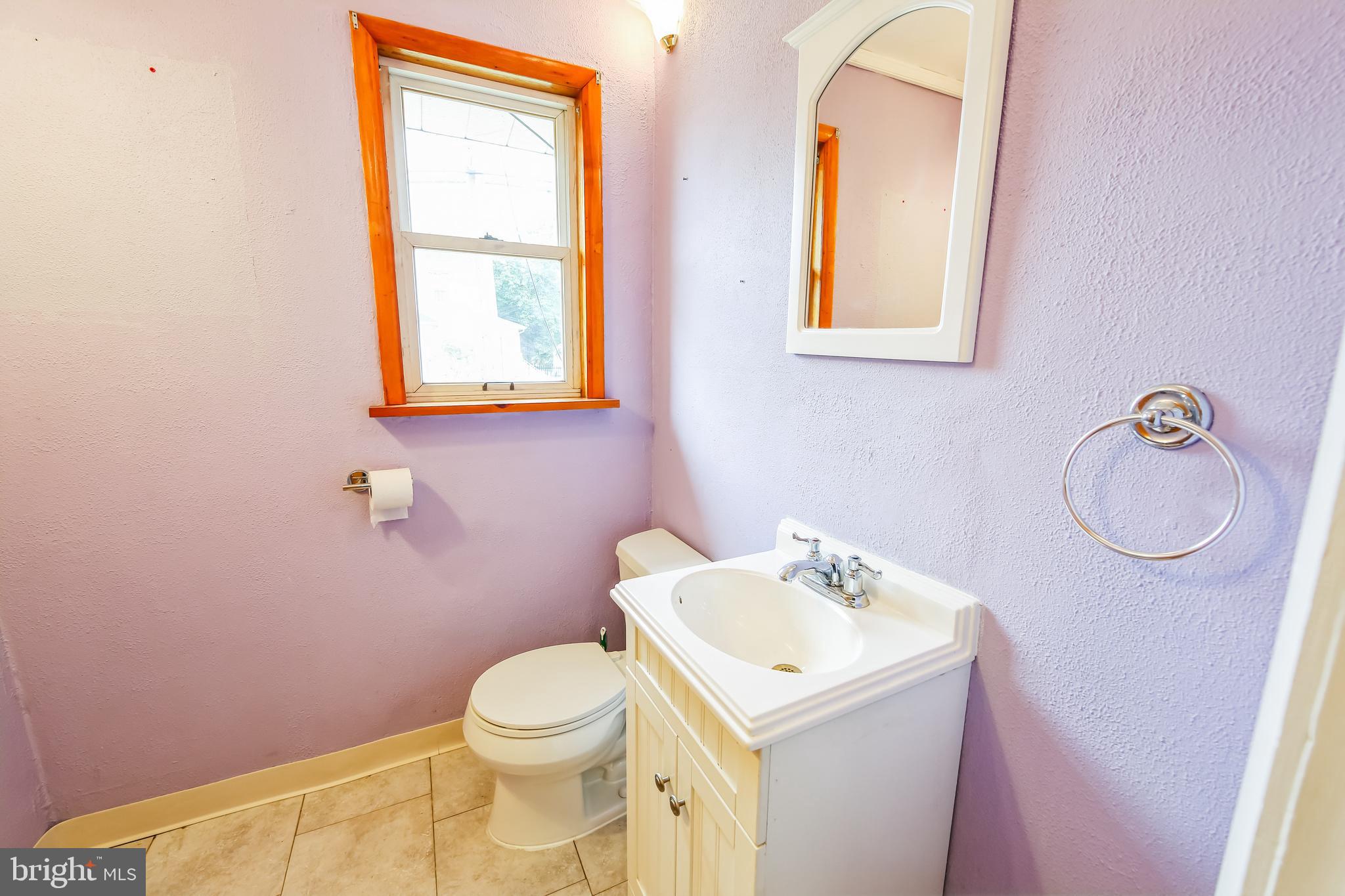 200 East Roland Road Brookhaven, PA 19015 - Photo 10 of 47 a bathroom with a toilet sink vanity and mirror