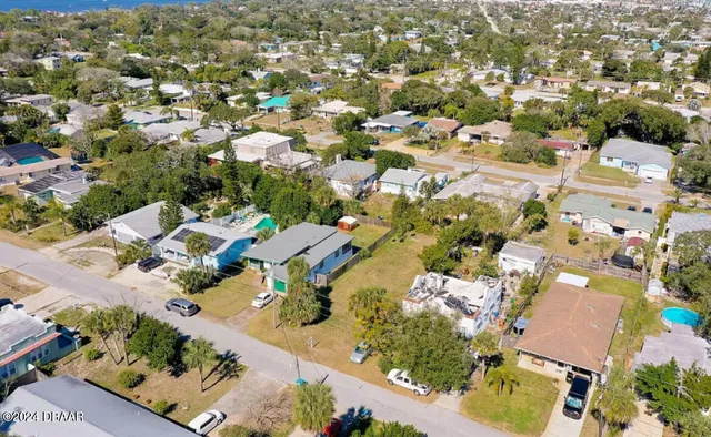 an aerial view of residential houses with outdoor space