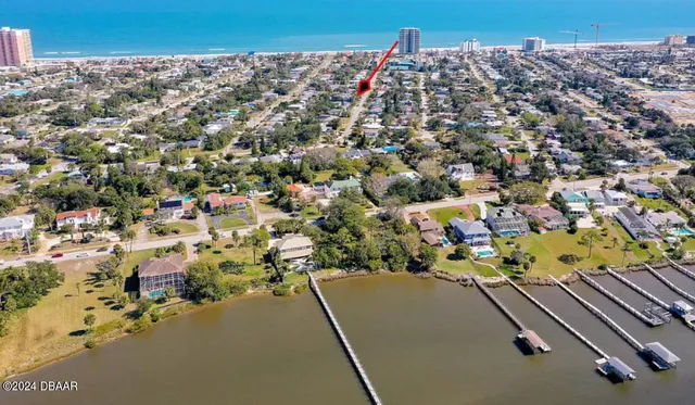 an aerial view of multiple houses with yard