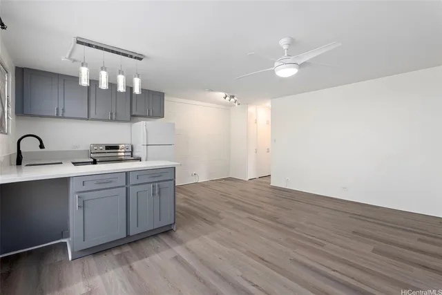 a kitchen with a sink cabinets and stainless steel appliances