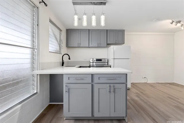a kitchen with a sink cabinets and a window