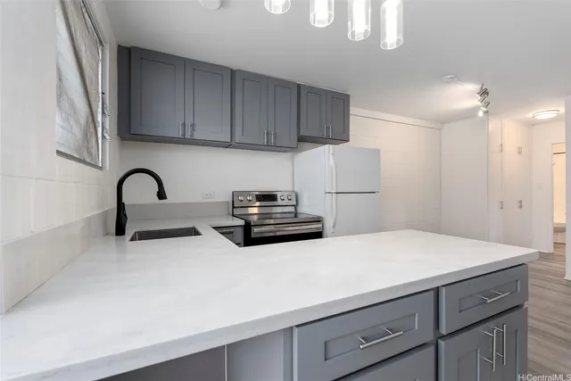 a kitchen with a sink and a refrigerator