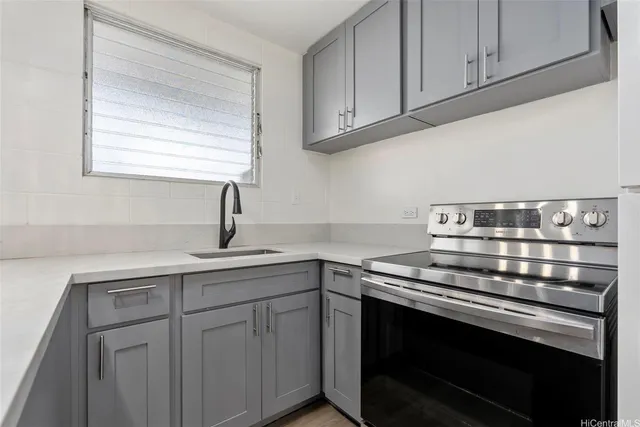 a kitchen with a sink stove and cabinets