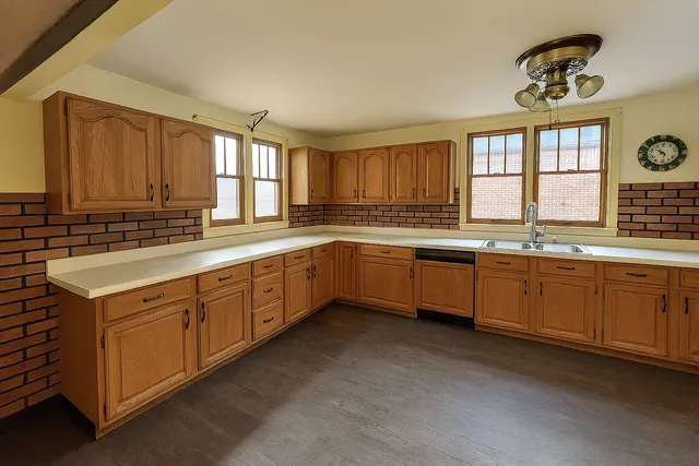 a kitchen with sink window and cabinets