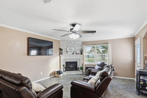 a living room with furniture a fireplace and a flat screen tv