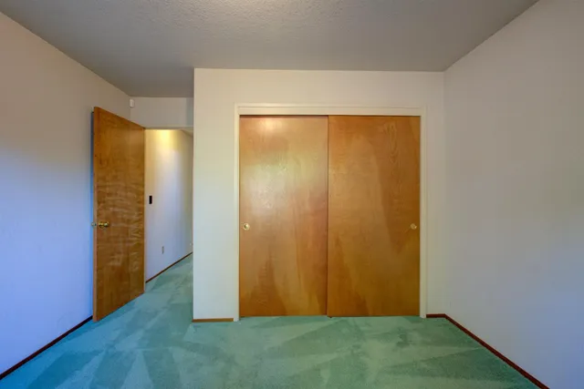 an empty room with closet area