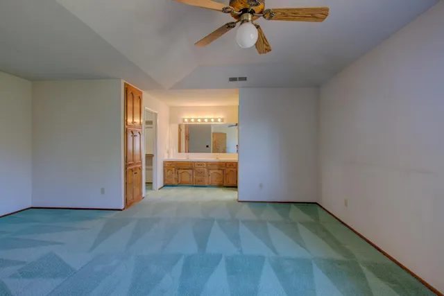 a view of a room with a window and wooden floor