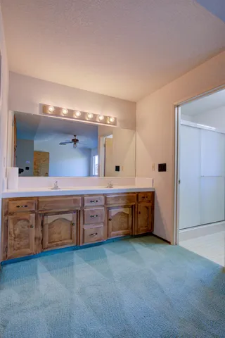 a large bathroom with a double vanity sink and a mirror