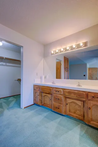 a large bathroom with a large tub and sink