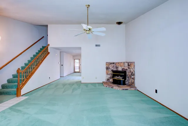 a view of an empty room with a fireplace