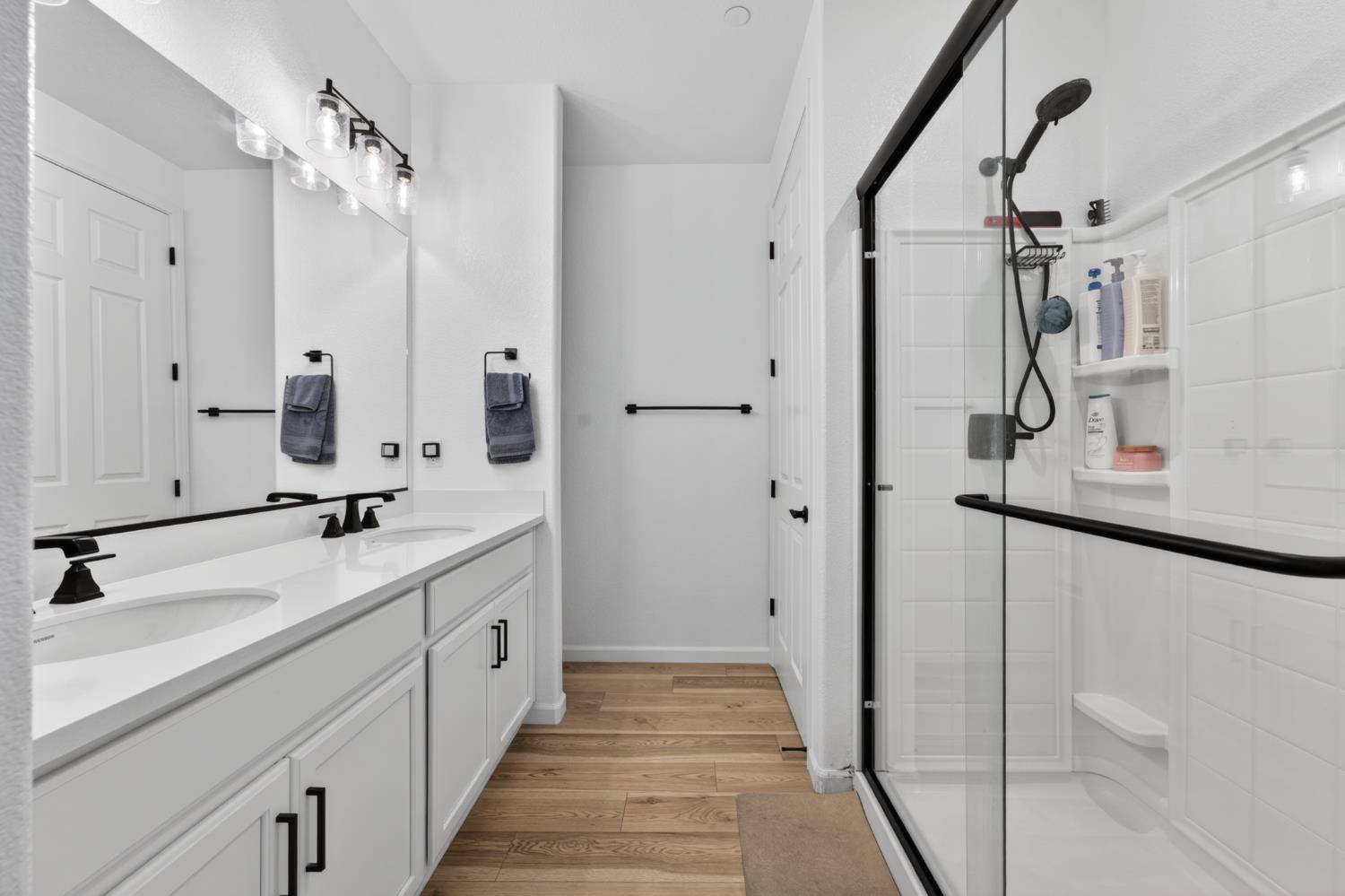 11986 Granzella Way Rancho Cordova, CA 95742 - Photo 23 of 55 Primary Bathroom has 2 sinks and walk-in shower, there are linen shelves on the other side of the partial wall