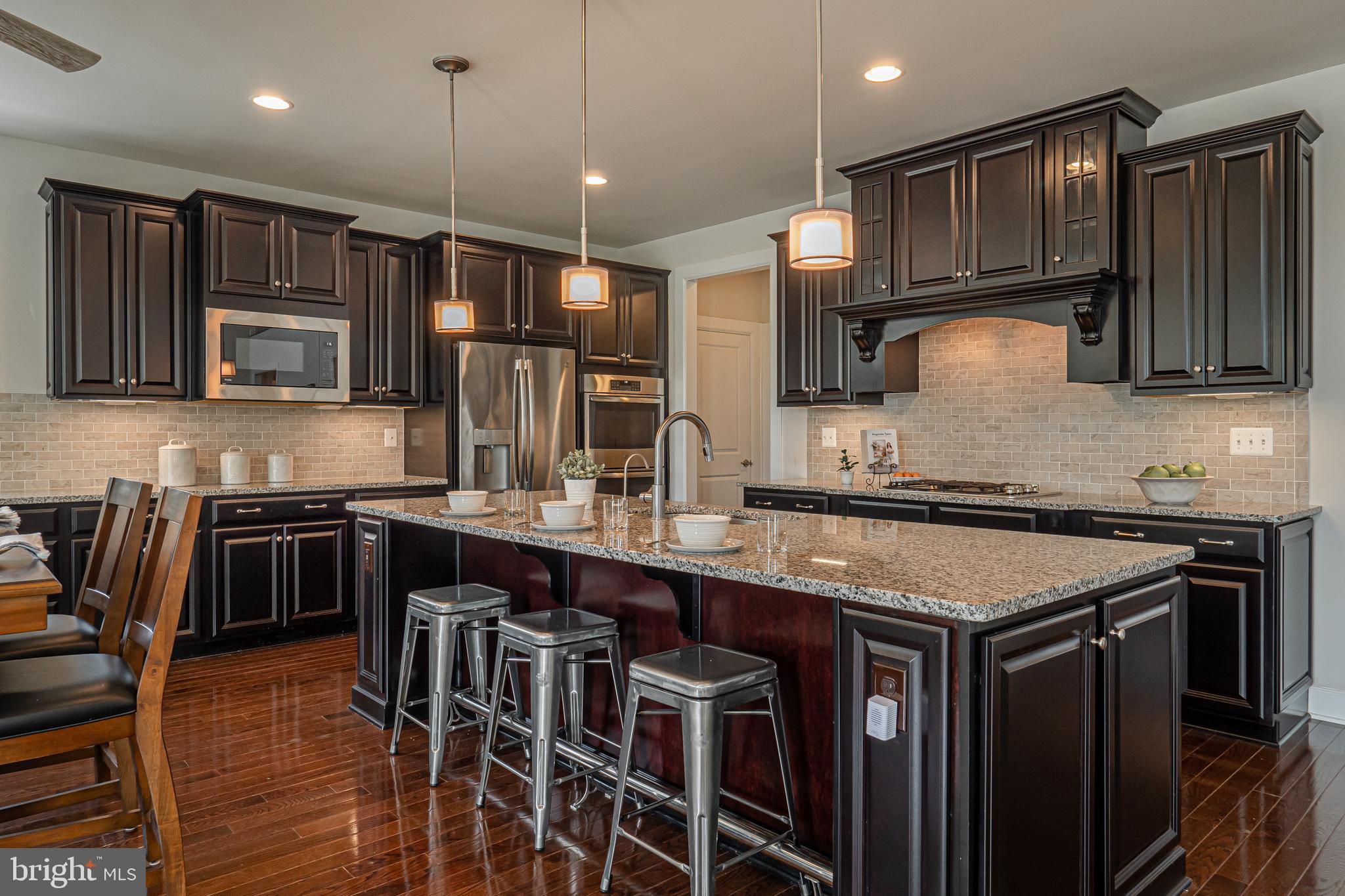 731 Stonecliffe Road Malvern, PA 19355 - Photo 20 of 81 a kitchen with stainless steel appliances granite countertop a stove a sink and a refrigerator
