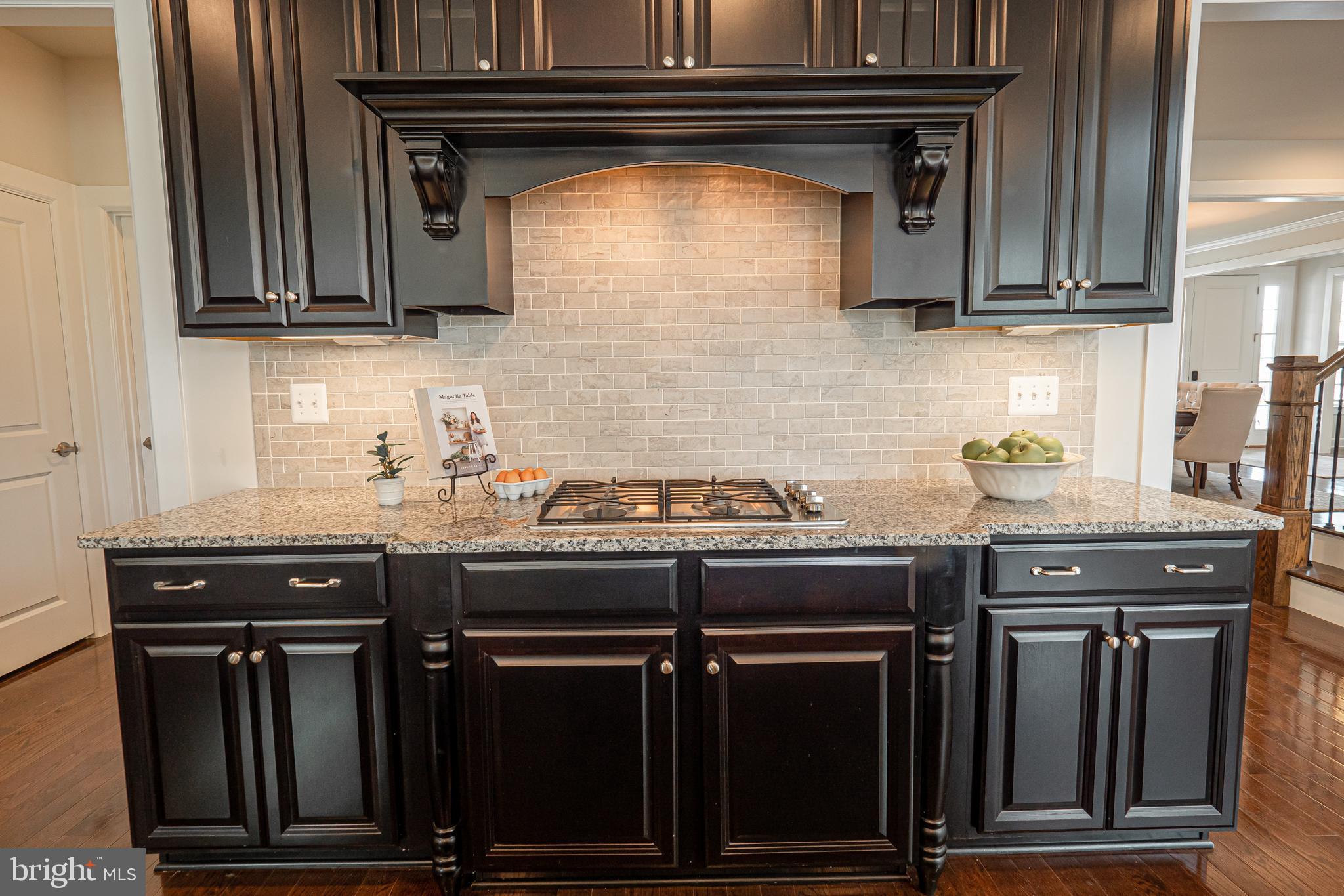 731 Stonecliffe Road Malvern, PA 19355 - Photo 22 of 81 a kitchen with stainless steel appliances granite countertop a stove and a microwave