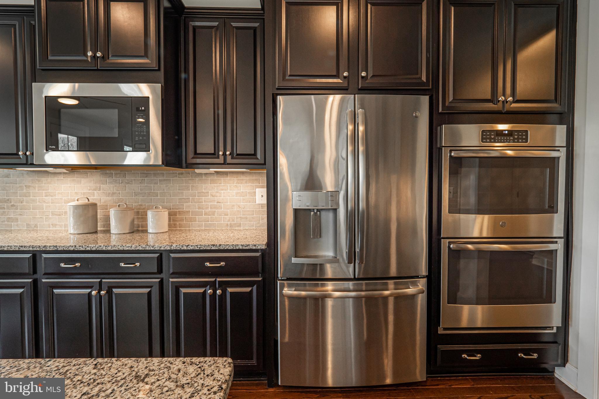 731 Stonecliffe Road Malvern, PA 19355 - Photo 28 of 81 a kitchen with a refrigerator and cabinets