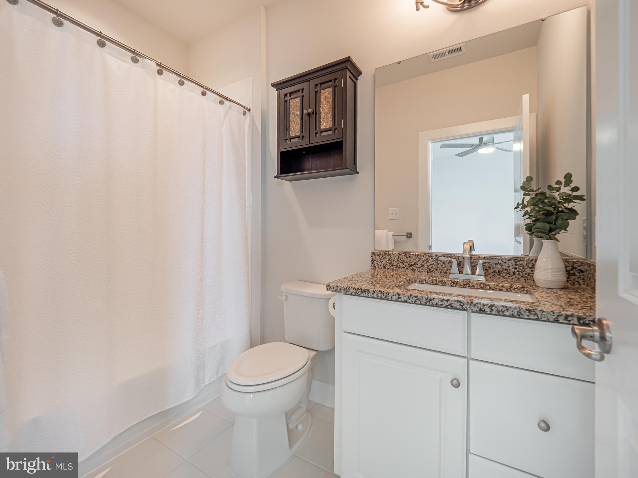 731 Stonecliffe Road Malvern, PA 19355 - Photo 65 of 81 a bathroom with a granite countertop sink a toilet and a mirror