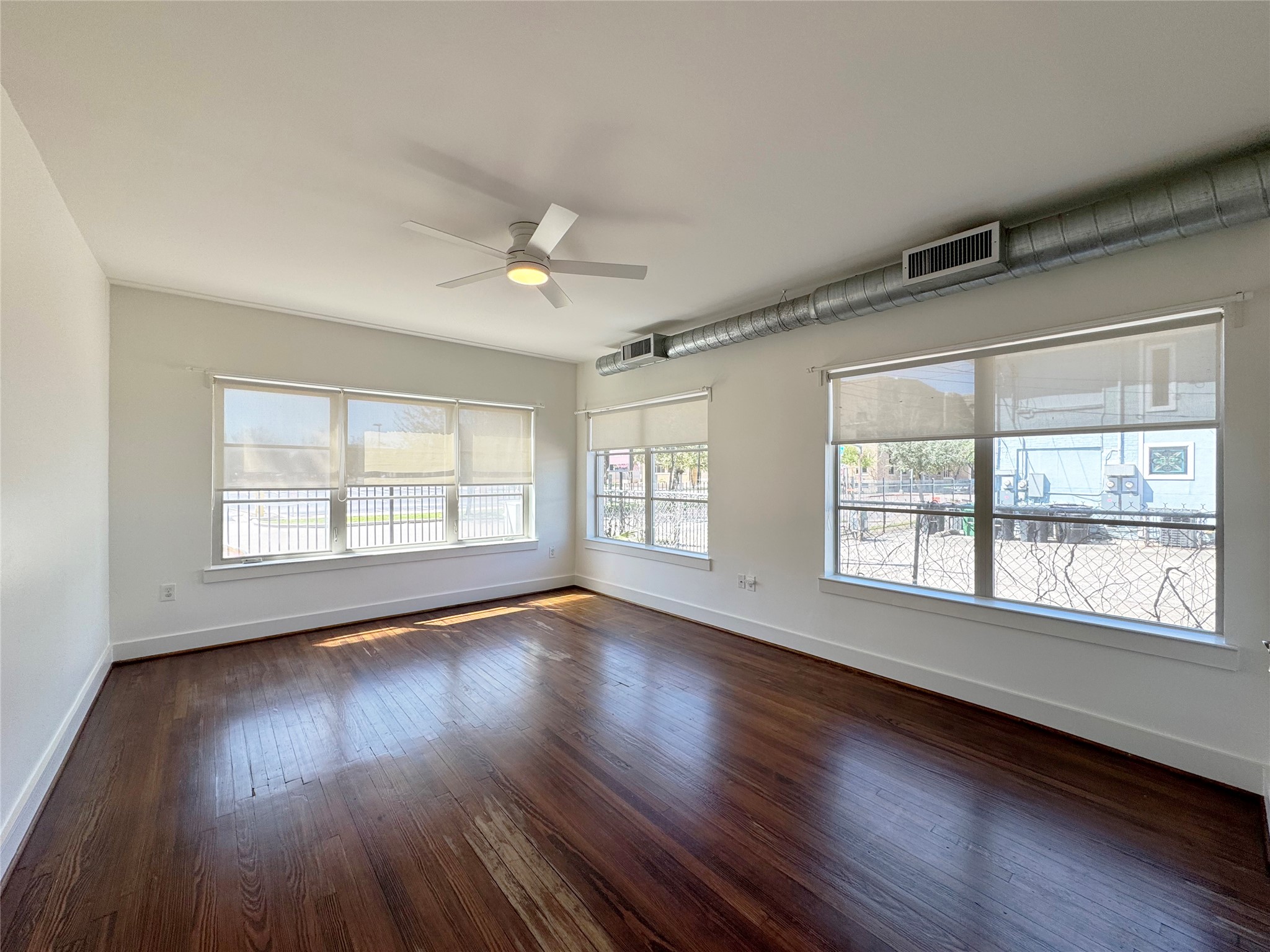 1509 Holman Street, Unit 2 Houston, TX 77004 - Photo 2 of 10 a view of an empty room with wooden floor and a window