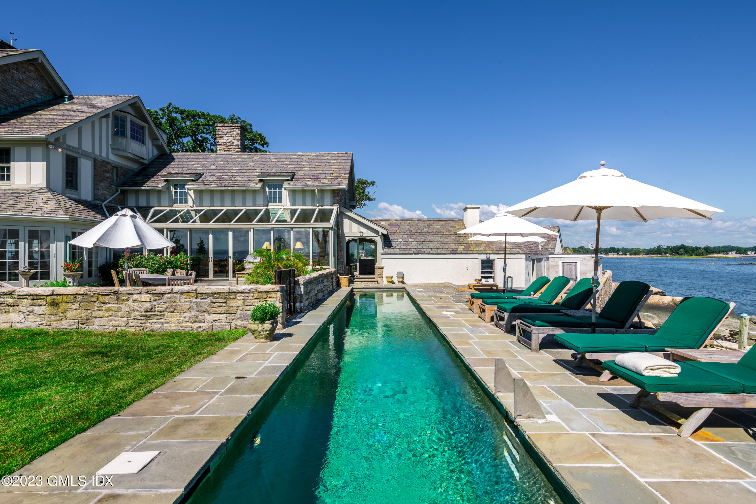 140 Wallacks Drive Stamford, CT 06902 - Photo 15 of 26 a view of a table and chairs under an umbrella