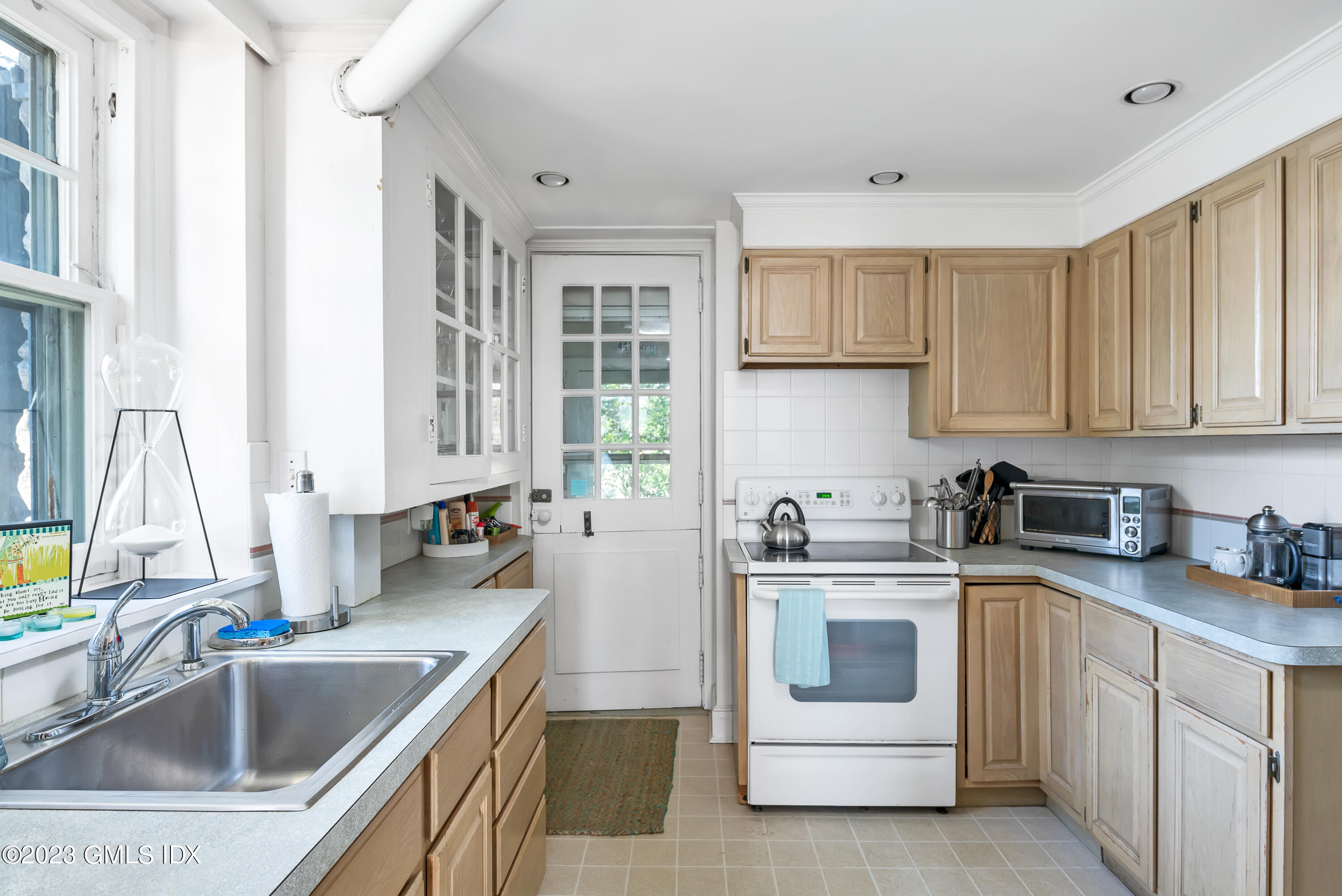 140 Wallacks Drive Stamford, CT 06902 - Photo 22 of 26 a kitchen with a sink stove top oven and cabinets