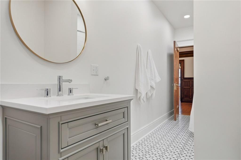 4749 Wallingford Street Pittsburgh, PA 15213 - Photo 38 of 49 a bathroom with a sink and a mirror