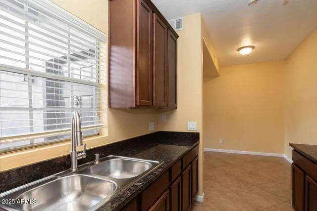 a kitchen that has a sink and a granite counter tops