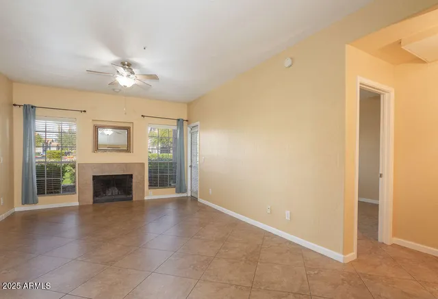 a view of an empty room with a fireplace and a window