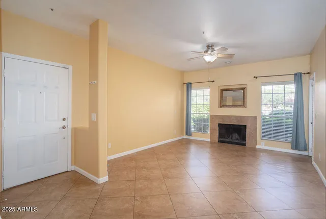 wooden floor fireplace and windows in an empty room