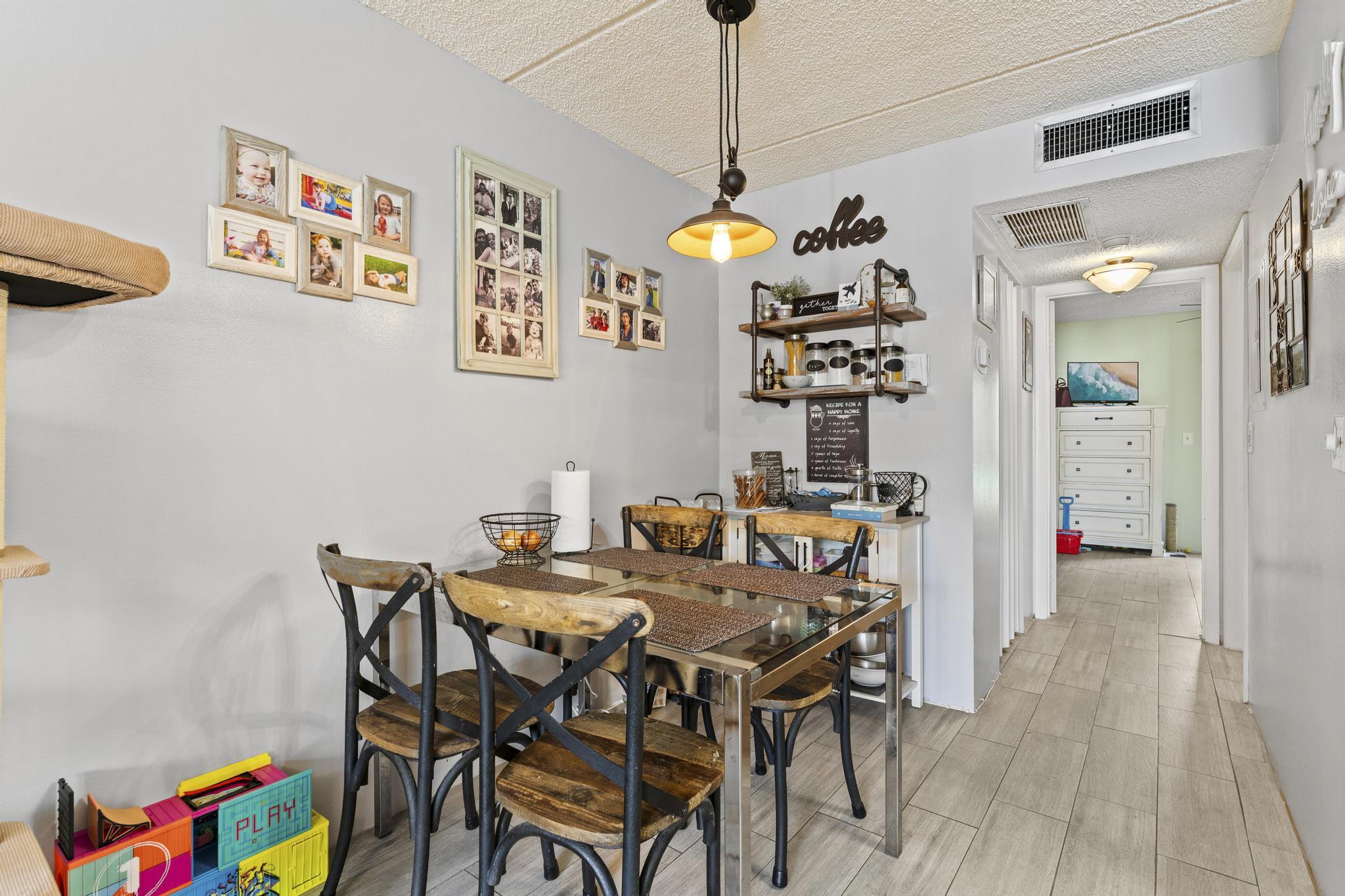 2000 Springdale Boulevard, Unit 209 Palm Springs, FL 33461 - Photo 11 of 26 a view of a dining room with furniture and wooden floor
