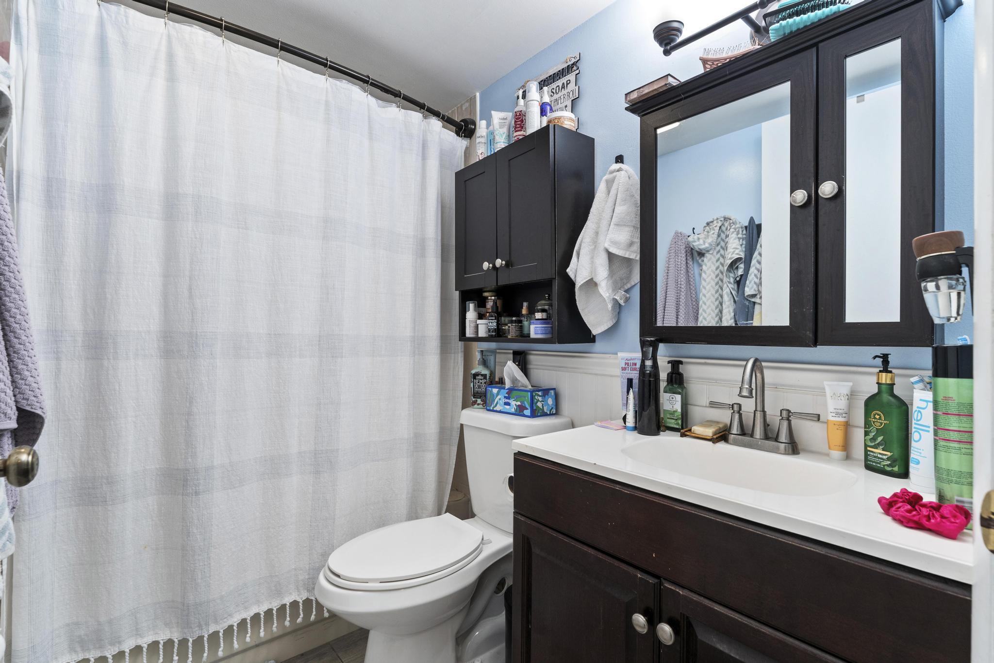 2000 Springdale Boulevard, Unit 209 Palm Springs, FL 33461 - Photo 12 of 26 a bathroom with a sink vanity mirror and toilet