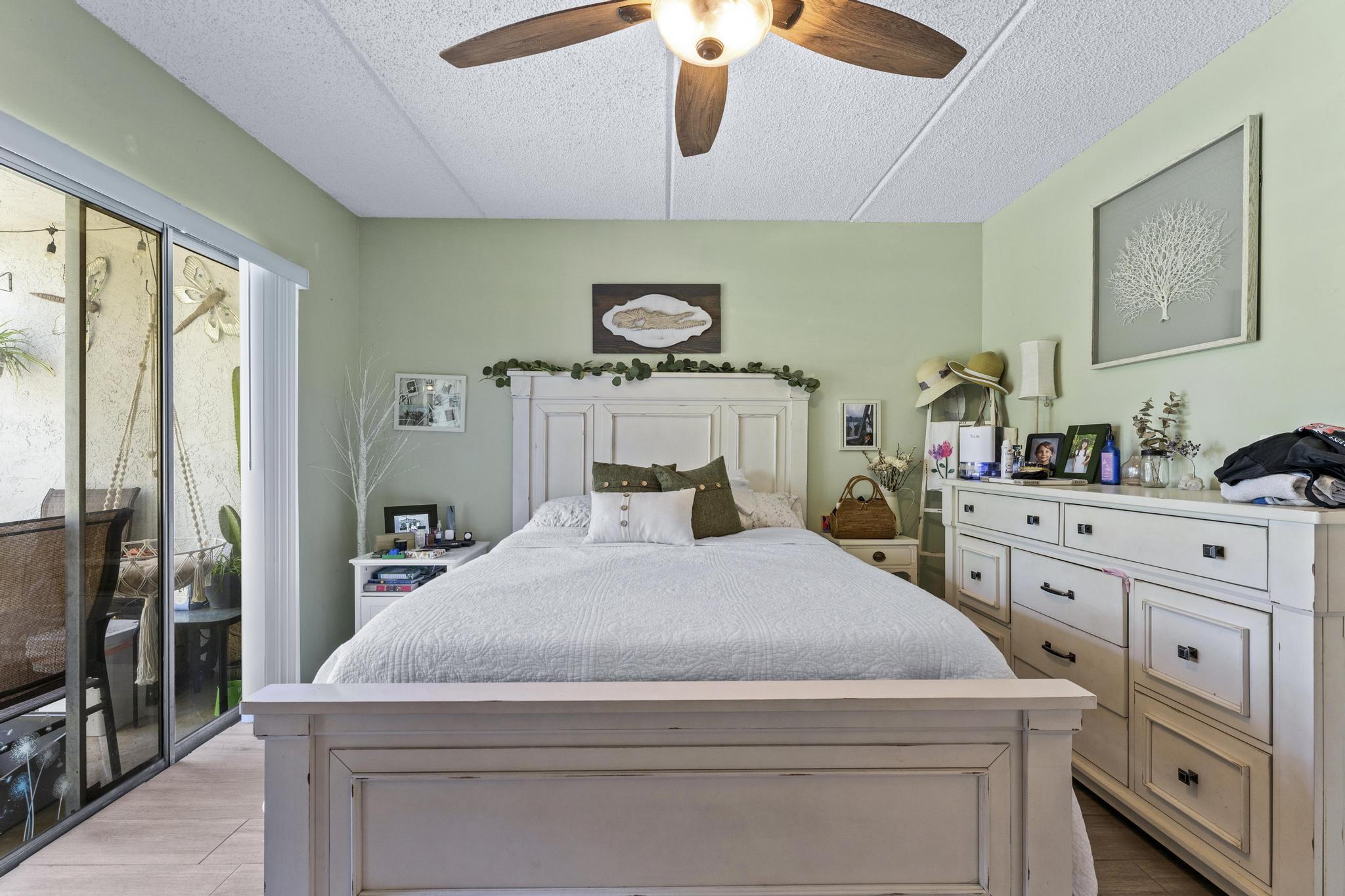 2000 Springdale Boulevard, Unit 209 Palm Springs, FL 33461 - Photo 13 of 26 a bedroom with a bed and a flat tv screen on the dresser
