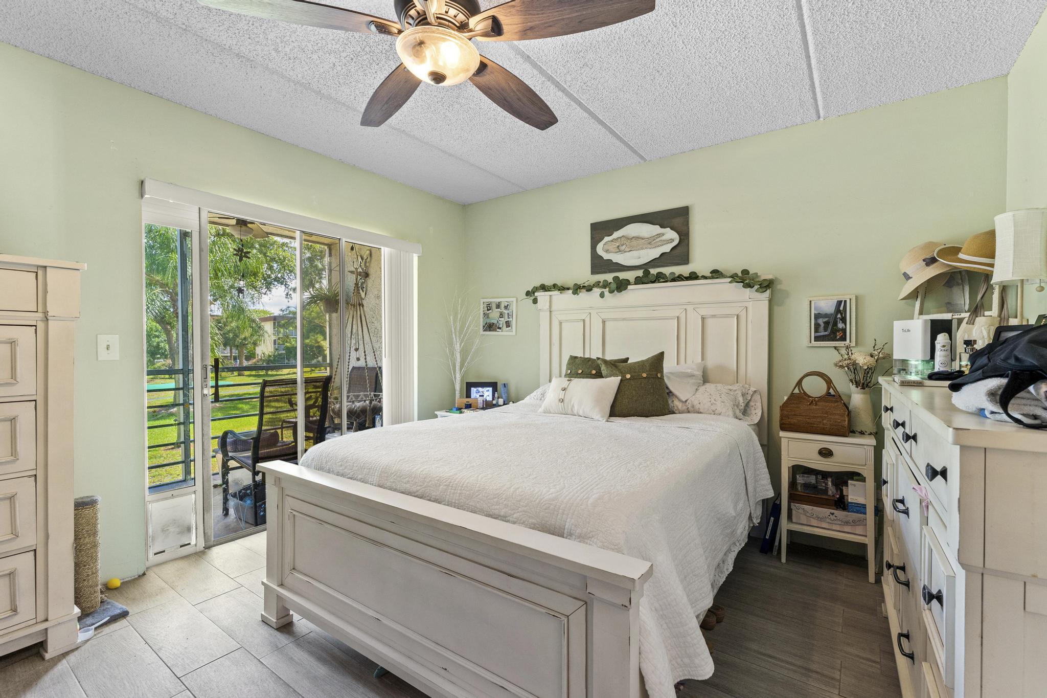 2000 Springdale Boulevard, Unit 209 Palm Springs, FL 33461 - Photo 15 of 26 a bedroom with a bed and a chandelier