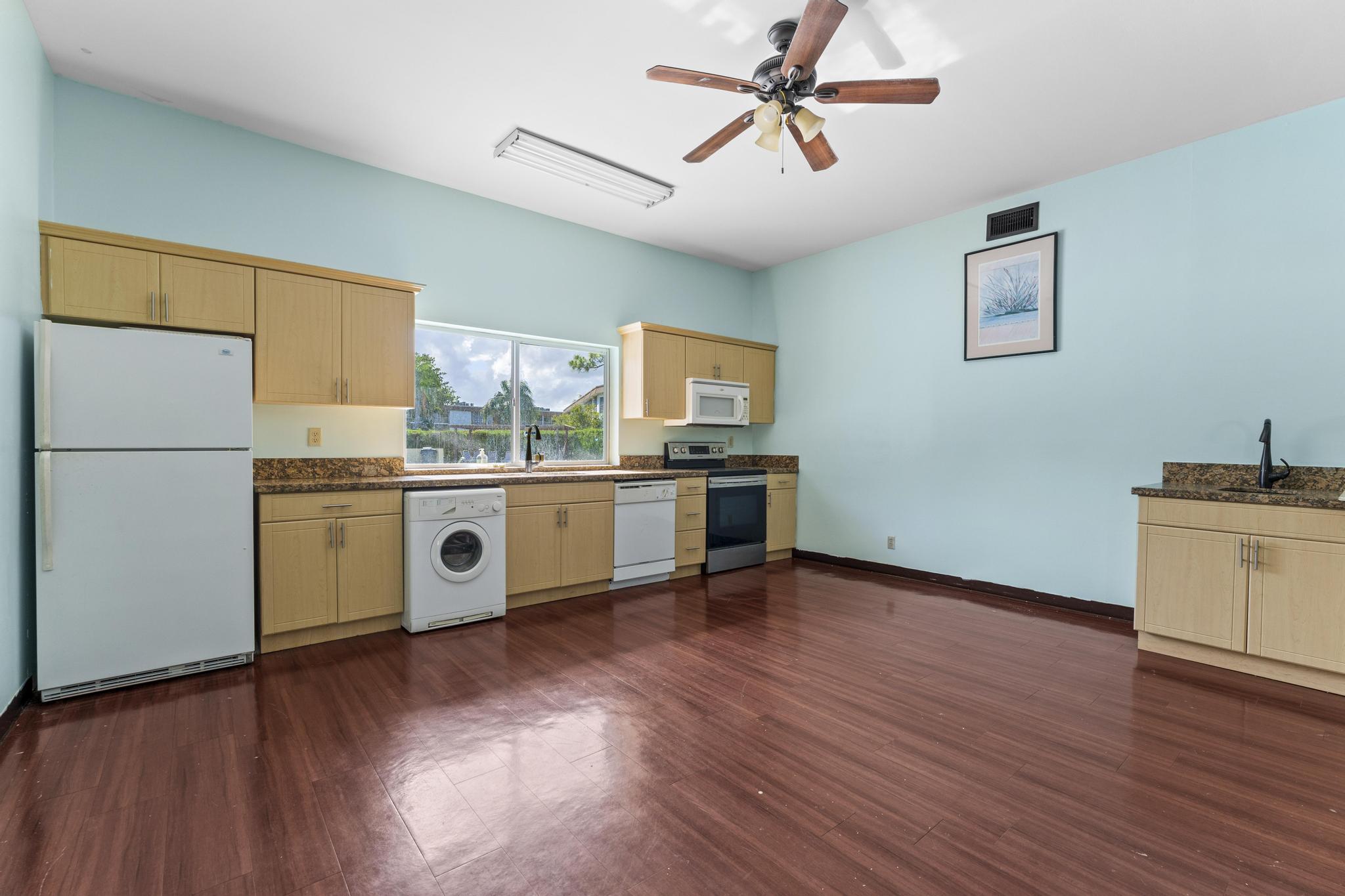 2000 Springdale Boulevard, Unit 209 Palm Springs, FL 33461 - Photo 21 of 26 a kitchen with stainless steel appliances a stove top oven and a refrigerator