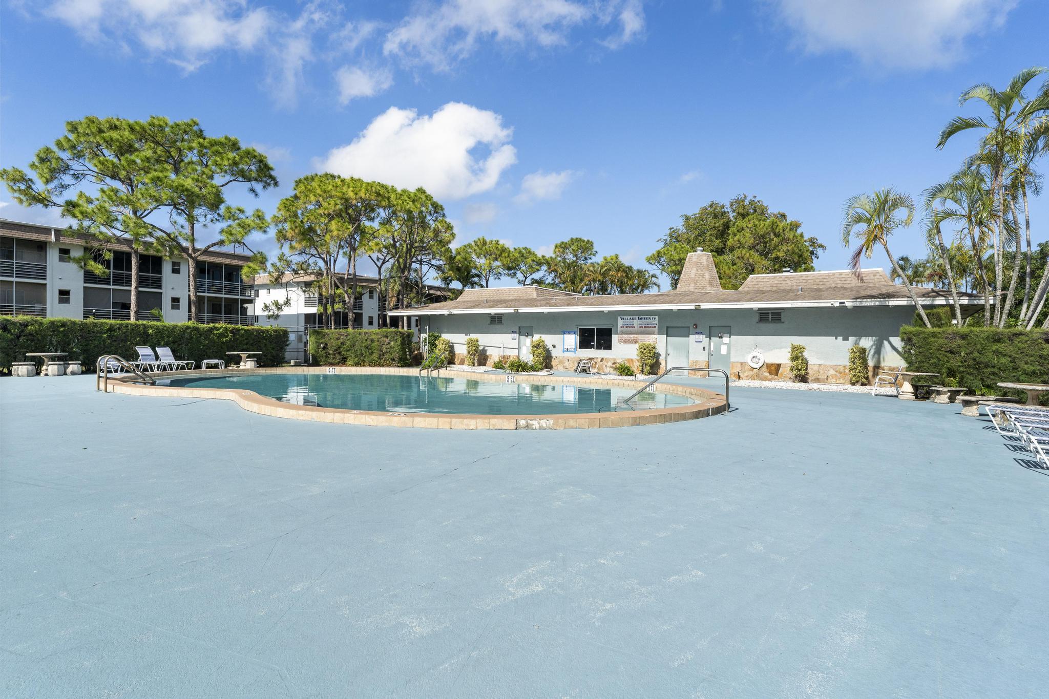 2000 Springdale Boulevard, Unit 209 Palm Springs, FL 33461 - Photo 23 of 26 a view of a building with a lot of big trees