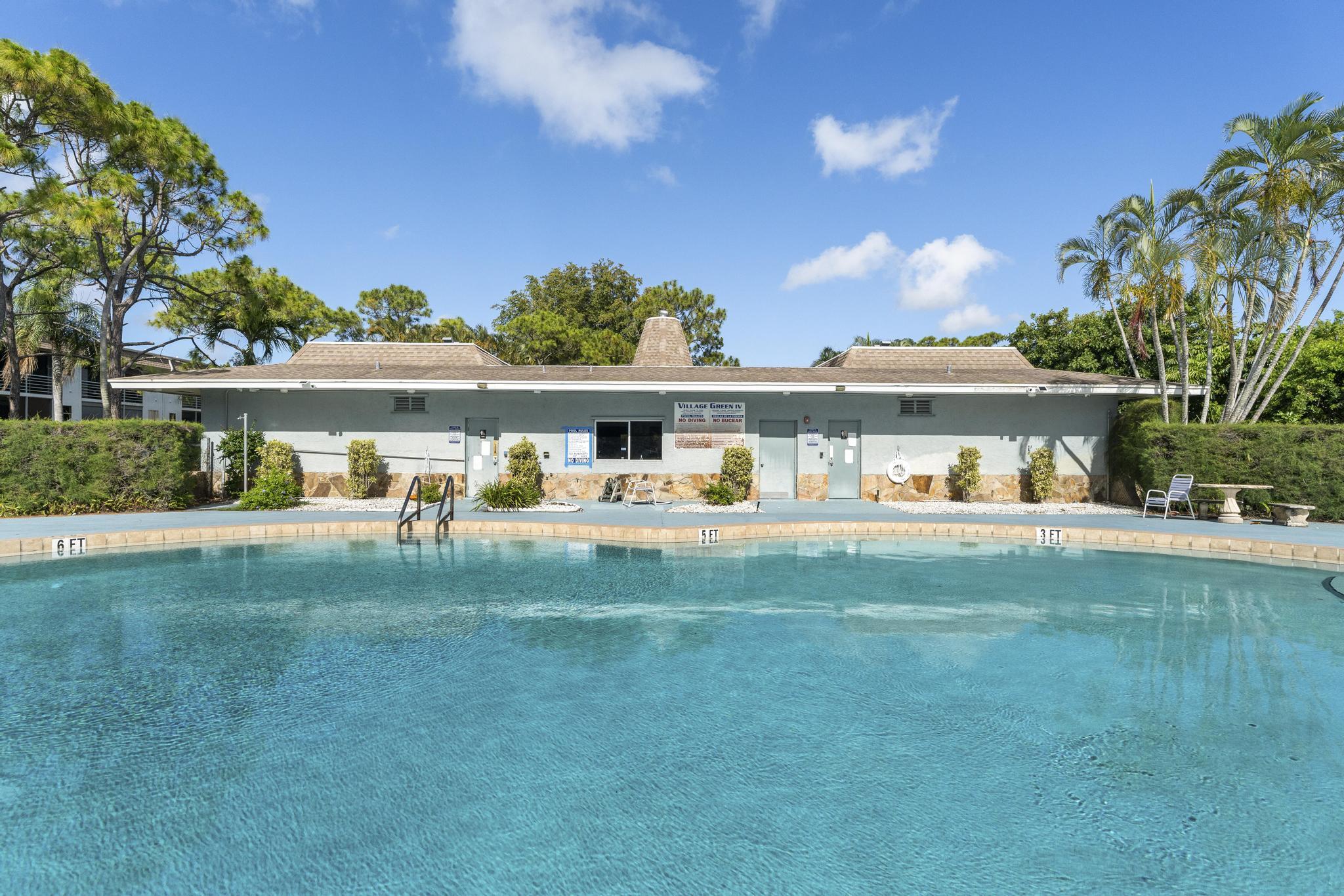 2000 Springdale Boulevard, Unit 209 Palm Springs, FL 33461 - Photo 24 of 26 a front view of a house with a garden
