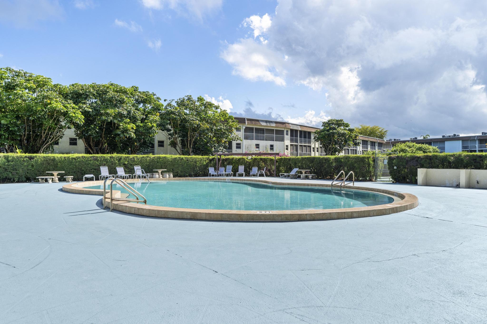 2000 Springdale Boulevard, Unit 209 Palm Springs, FL 33461 - Photo 26 of 26 a view of a house with a swimming pool and a yard
