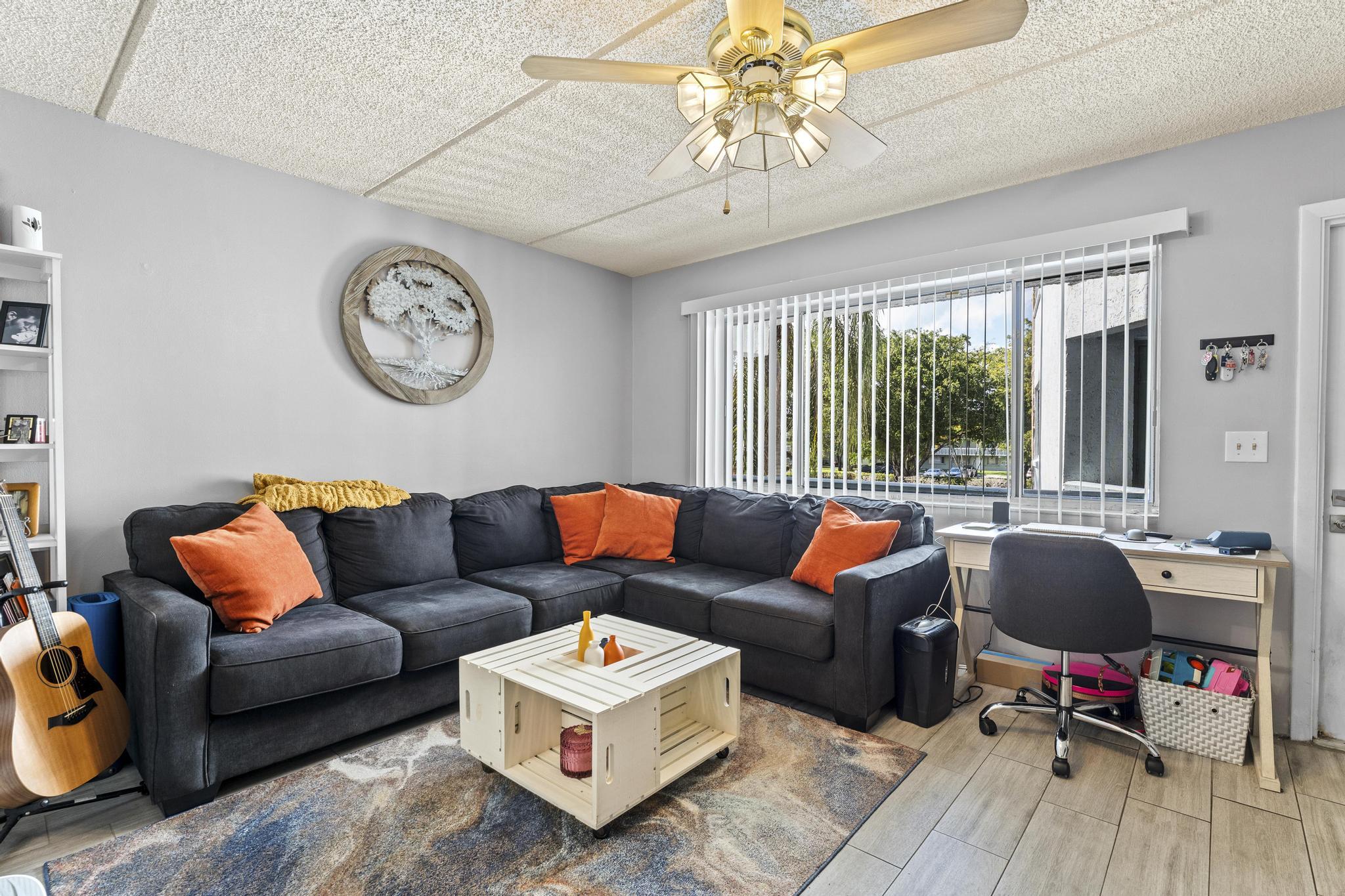 2000 Springdale Boulevard, Unit 209 Palm Springs, FL 33461 - Photo 5 of 26 a living room with furniture and a large window