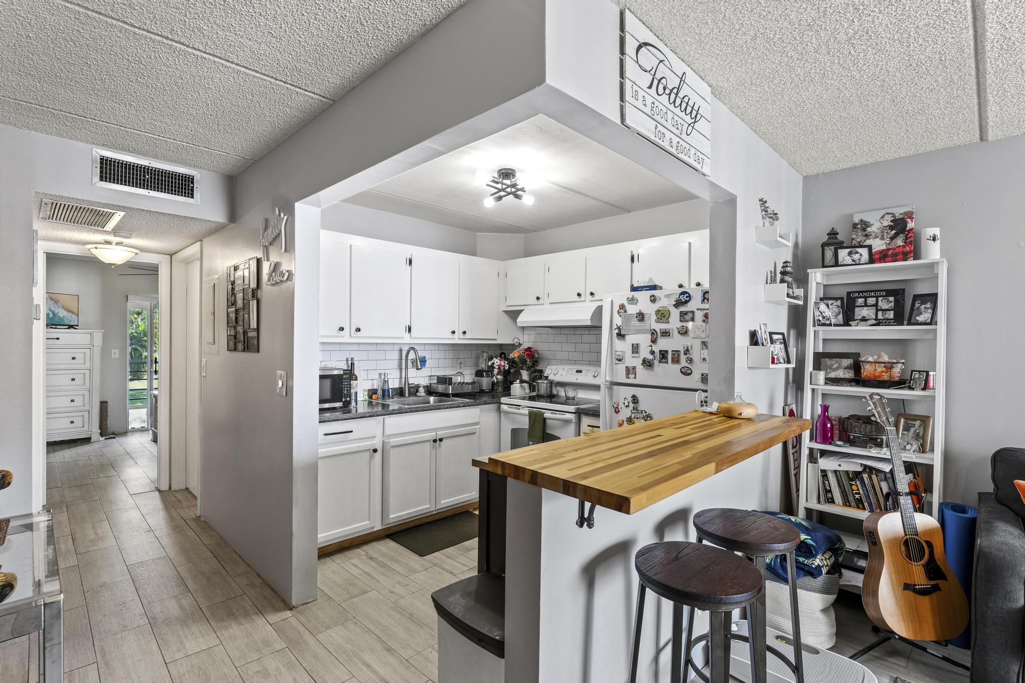 2000 Springdale Boulevard, Unit 209 Palm Springs, FL 33461 - Photo 7 of 26 a kitchen with stainless steel appliances granite countertop a stove refrigerator and cabinets