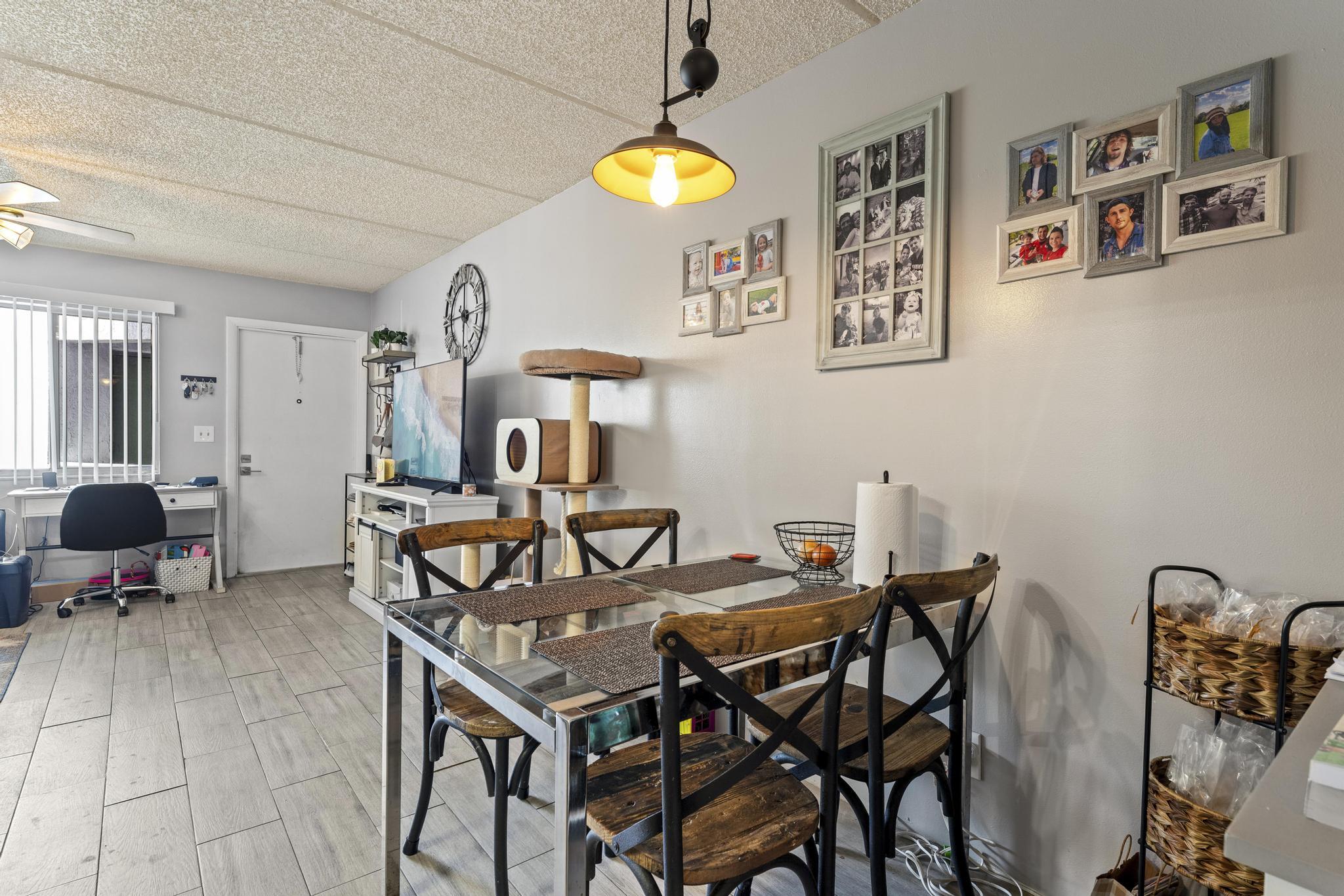 2000 Springdale Boulevard, Unit 209 Palm Springs, FL 33461 - Photo 10 of 26 a view of a dining room with furniture and chandelier