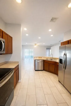 a kitchen with stainless steel appliances cabinets a sink and a counter top space