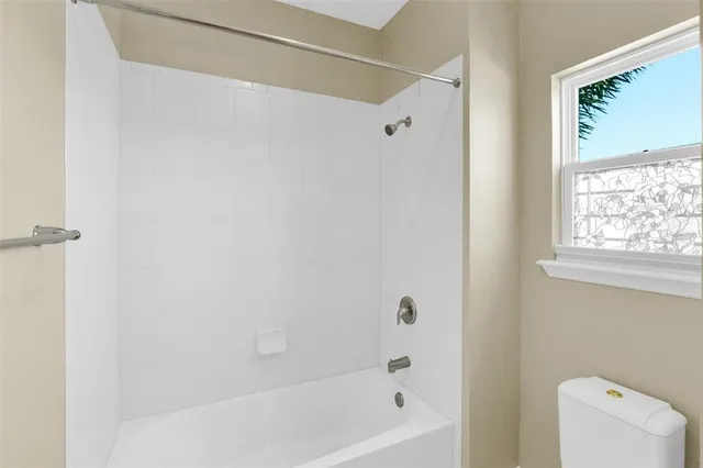 a view of room with a ceiling fan and window