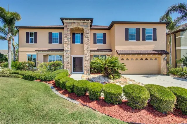 a front view of a house with a yard and garage