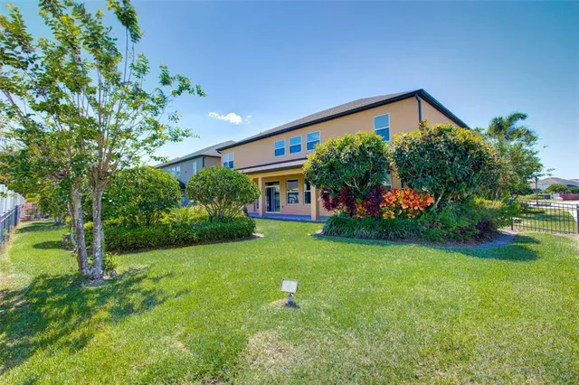 a view of a garden with lawn chairs and a fountain