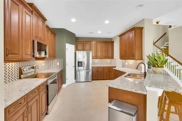 a kitchen with a sink stove and cabinets