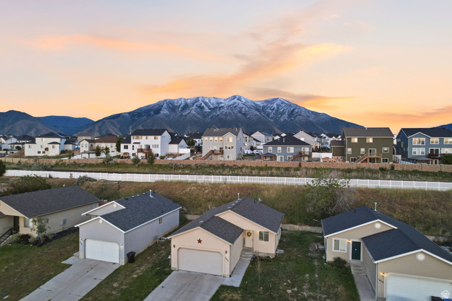 1662 East Ridgefield Road Spanish Fork, UT 84660 - Photo 18 of 18 Residential neighborhood with diverse home styles, featuring a prominent snow-capped mountain range in the background